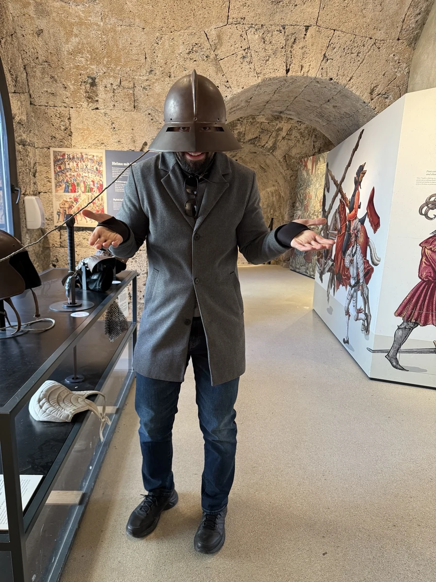 Felipe trying on medieval armour in a museum
